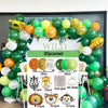 A set of green and yellow safari jungle balloon garland arch kit with palm leaves and various accessories