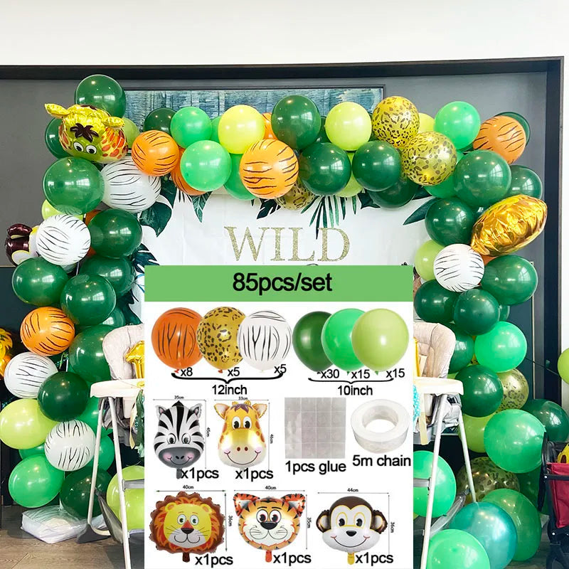 A set of green and yellow safari jungle balloon garland arch kit with palm leaves and various accessories