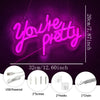 Pink neon sign spelling You're Pretty glowing on a dark purple background with accessory details shown below