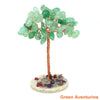 Natural crystal money tree decor featuring light green to emerald green leaves on a copper wire stem and base