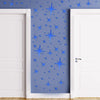 Blue star pattern wall stickers applied to a light blue wall between two white doors.