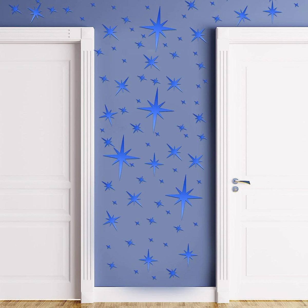 Blue star pattern wall stickers applied to a light blue wall between two white doors.