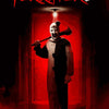 A menacing figure with a knife stands in a red hallway, featured on a Terrifier 2 movie poster art set.