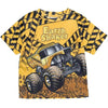 A yellow t-shirt featuring a full graphic print of the Earth Shaker Monster Jam Grave Digger vehicle.
