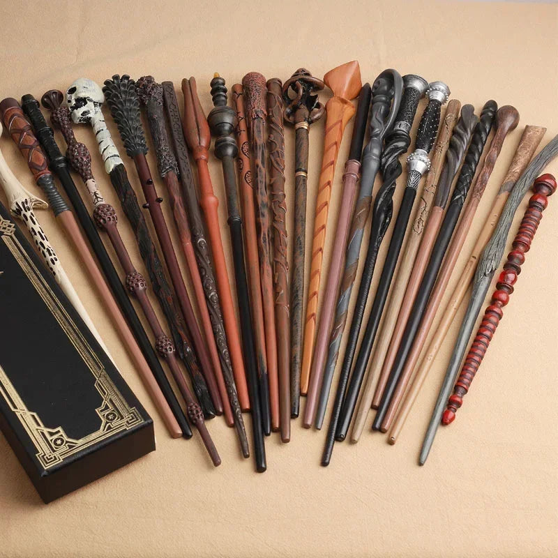 A collection of character-inspired metal and resin magic wands in various dark and earthy tones laid out on a light backgroun
