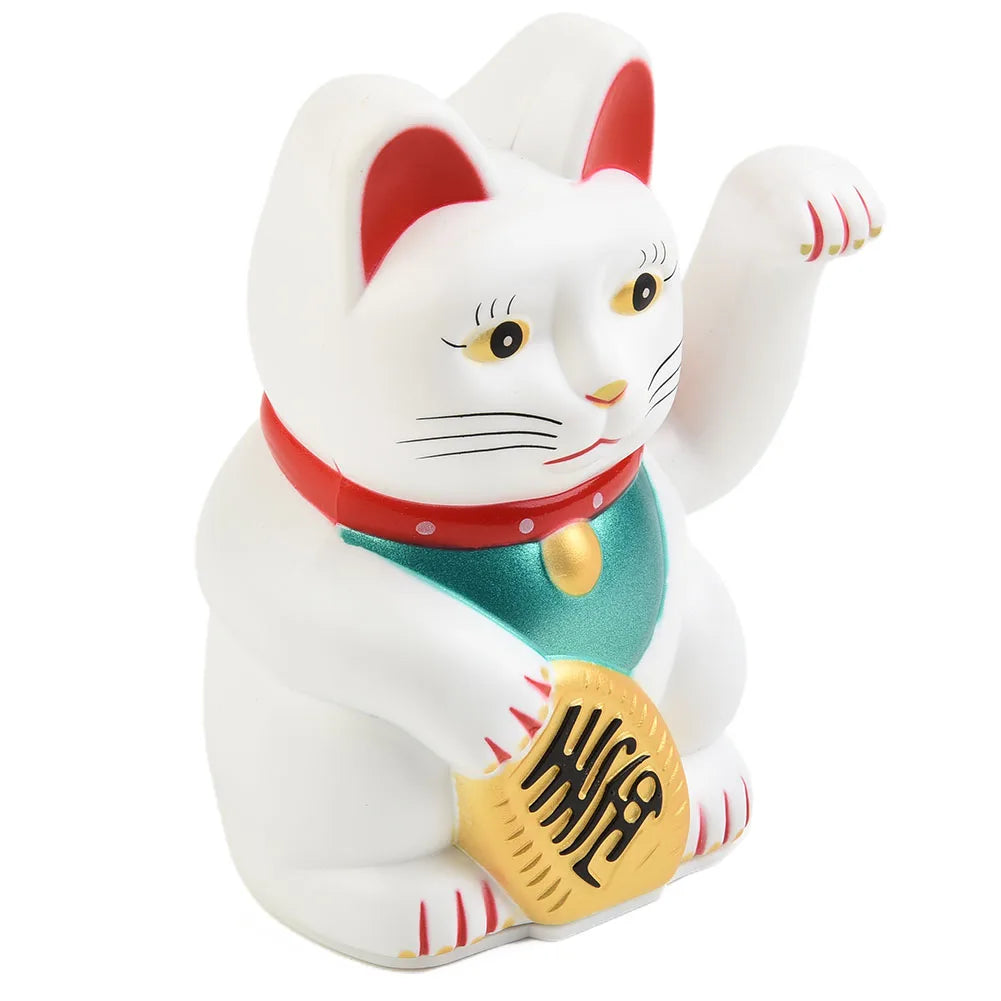 A white ceramic figurine of a cat wearing a red collar and green vest, sitting in a pose.