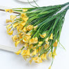 A bouquet of artificial yellow calla lily flowers on a green silk stem.
