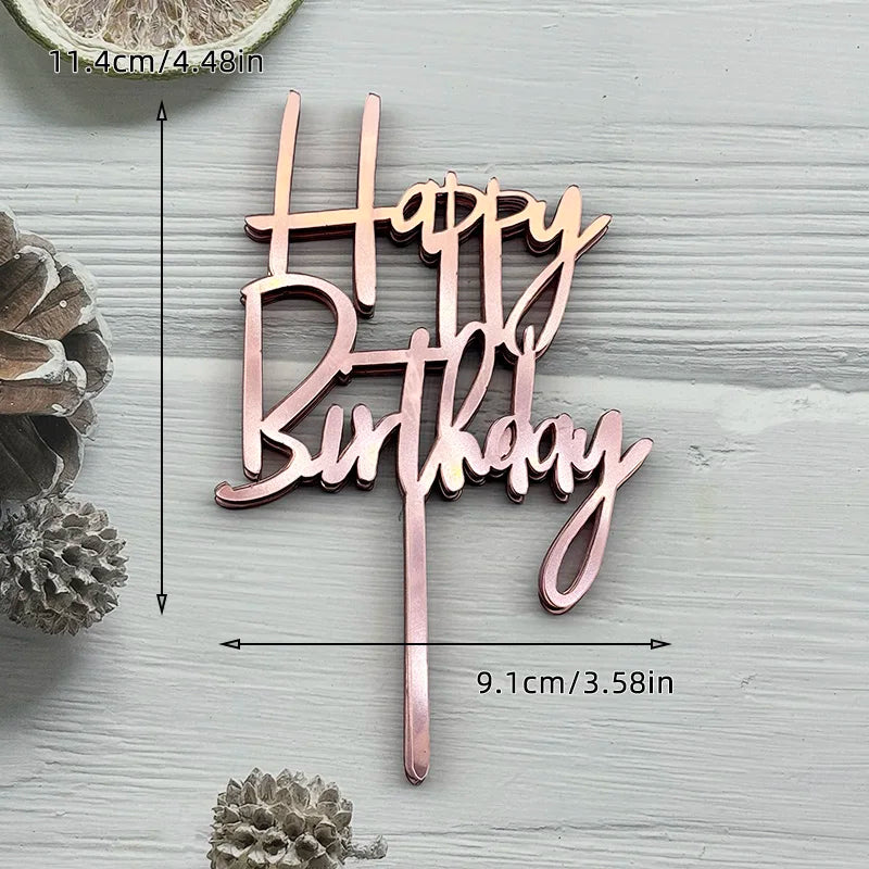 A pink acrylic birthday cake topper set with the words Happy Birthday on a stick.