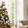 A festive Christmas tree decorated with gold and silver ornaments stands next to a window with colorful confetti falling.
