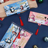 A festive cash gift box with 10 slots featuring winter and holiday designs, displayed next to a wooden board.