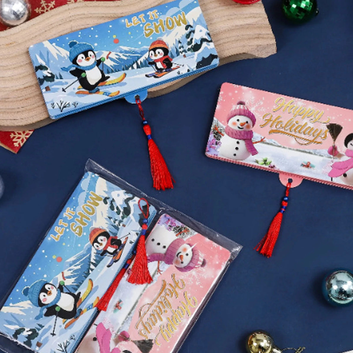 A festive cash gift box with 10 slots featuring winter and holiday designs, displayed next to a wooden board.