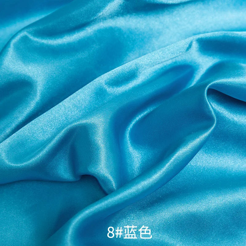 Blue satin fabric draped and folded for sewing or DIY projects