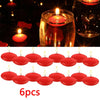 Six red floating candles in glass holders with lit wicks for romantic home décor