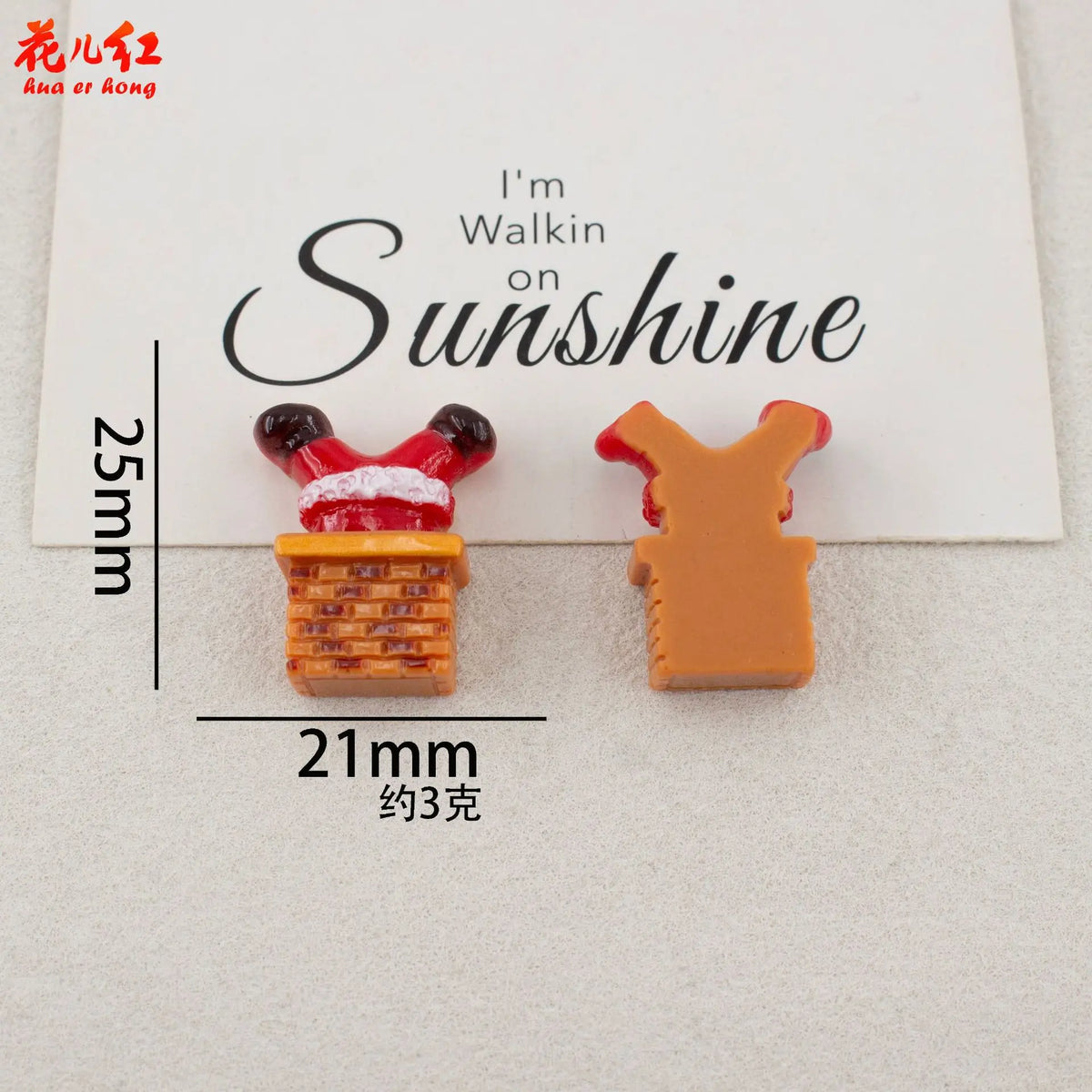 Two resin cabochons shaped like a walking figure on sunshine, one red and orange, the other orange.