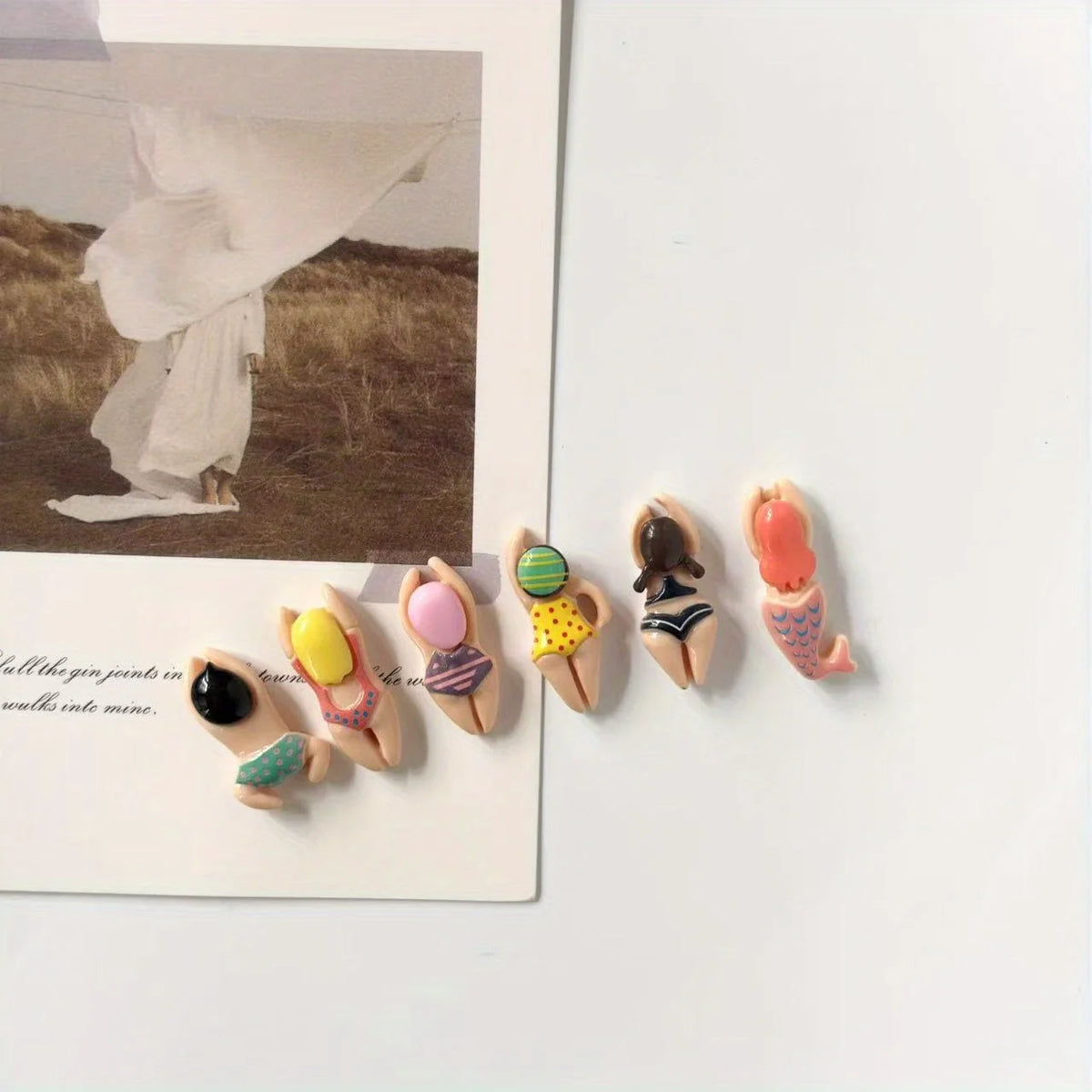 A set of six resin fridge magnets featuring various colors and designs.