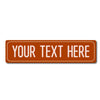 An orange rectangular metal street sign with the text YOUR TEXT HERE.