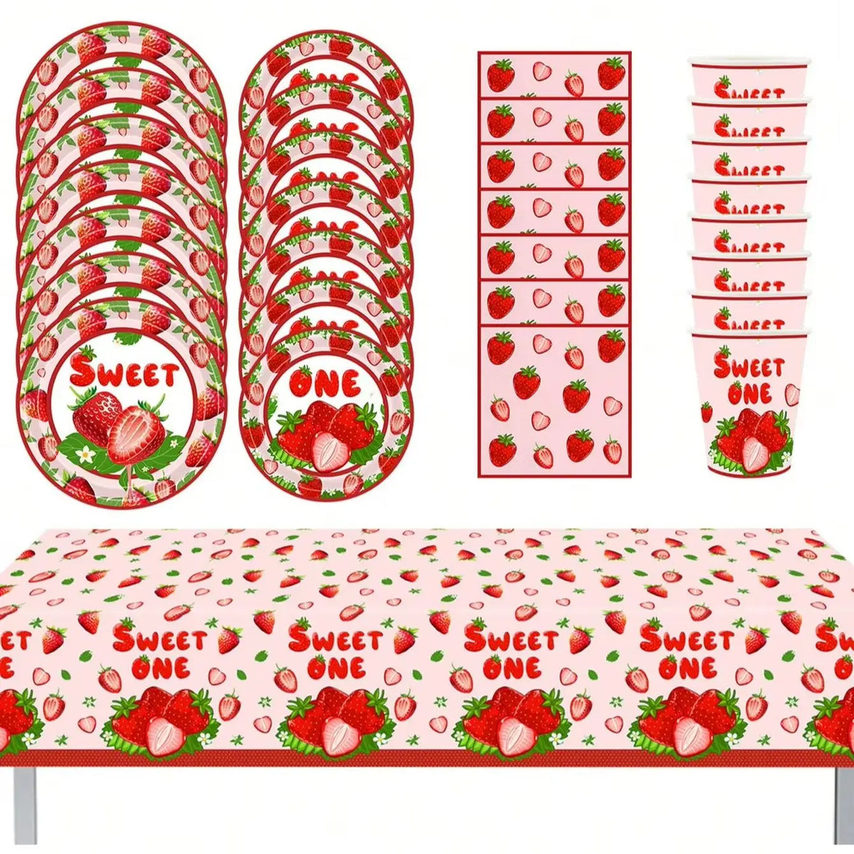 A set of red and green strawberry themed disposable birthday party tableware including plates, napkins, and cups.