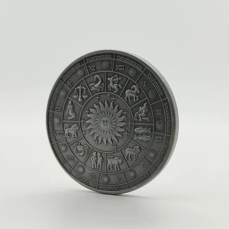 Une pièce commémorative avec un design de roue zodiaque rétro comprenant douze constellations et signes zodiacaux.