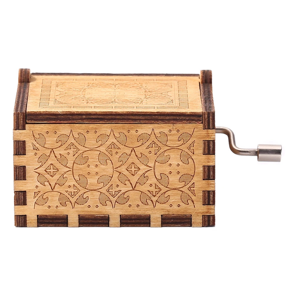 A vintage hand crank music box made of light wood with intricate geometric patterns.