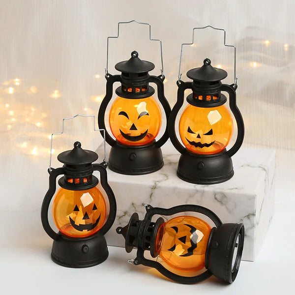A set of black hanging lanterns featuring glowing orange LED pumpkins and ghost designs.