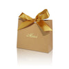 A brown paperboard gift box tied with a gold ribbon, featuring the word Merci printed on the top.