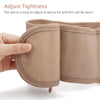 A hand adjusts the tightness of a beige inflatable lumbar support belt for back pain relief.