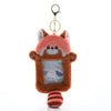 A fluffy, orange-brown cat-shaped keychain featuring a photo card inside.