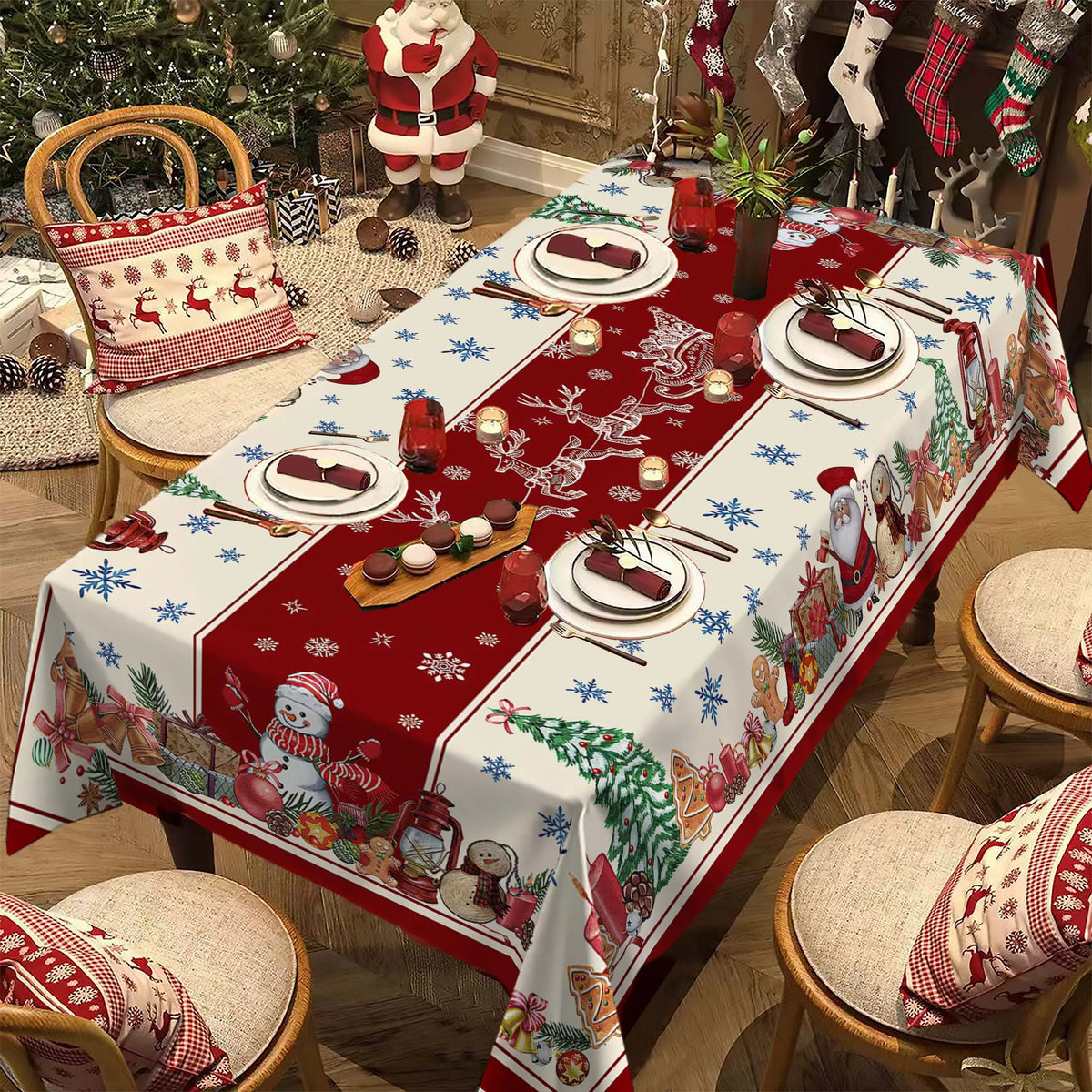 A festive red and white Christmas poinsettia rectangle tablecloth spread on a wooden table with holiday decorations.