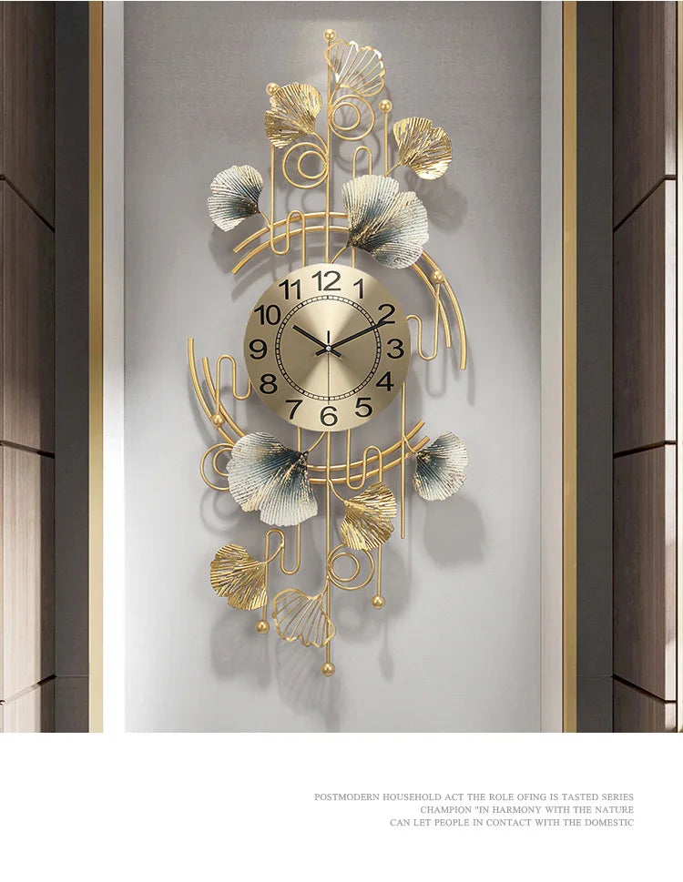 A gold-toned metal wall clock featuring a ginkgo leaf design with Roman numerals, mounted on a light gray wall.