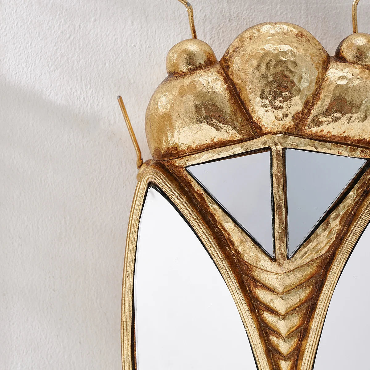 A golden resin hanging ornament shaped like a cicada, used as a home décor pendant.