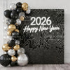 A dark square wall backdrop decorated with gold and silver balloons spelling out Happy New Year for a party.