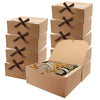 A stack of brown kraft paper gift boxes tied with dark ribbon bows.