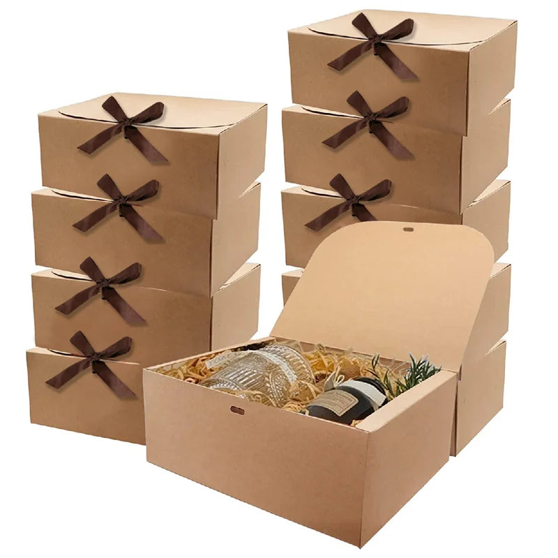 A stack of brown kraft paper gift boxes tied with dark ribbon bows.