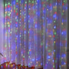 White curtain illuminated by colorful LED string lights creating a starry effect