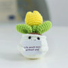 Handmade crochet sunflower desk companion with a smiling face in yellow and green.