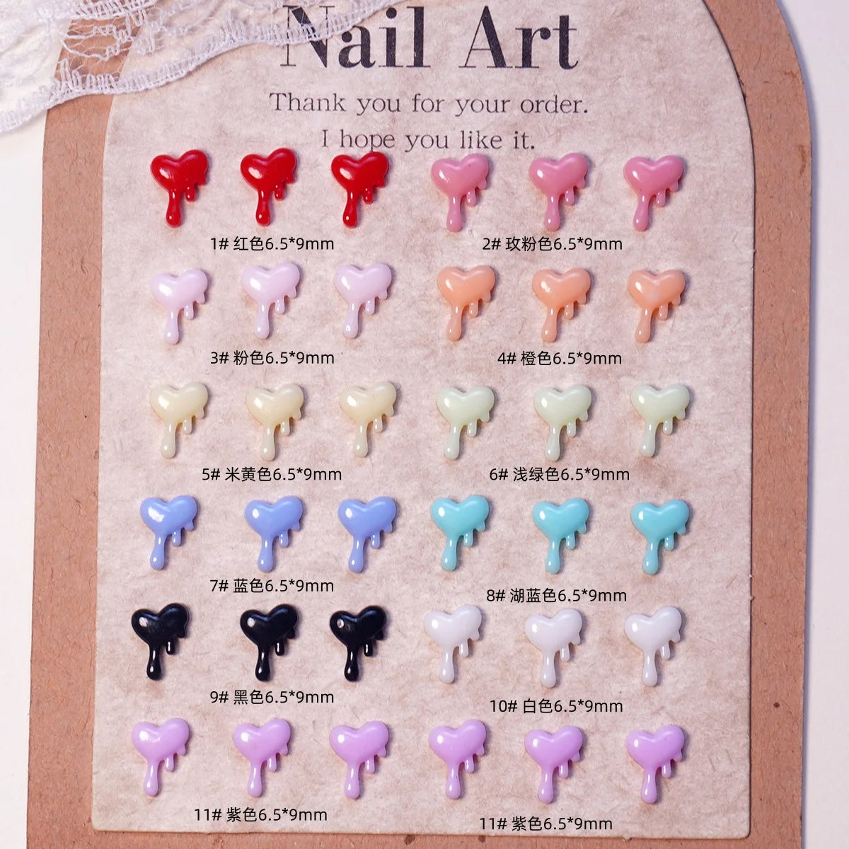 Exhibición de 11 collares de uñas de tortuga mini coloridos en varios tonos y tamaños sobre una tarjeta marrón.