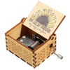 A vintage hand-cranked wooden music box with a lid featuring a sunflower design and a brass crank mechanism.