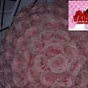 A close-up of a large bouquet of pink glitter artificial roses for DIY crafts and gifting.