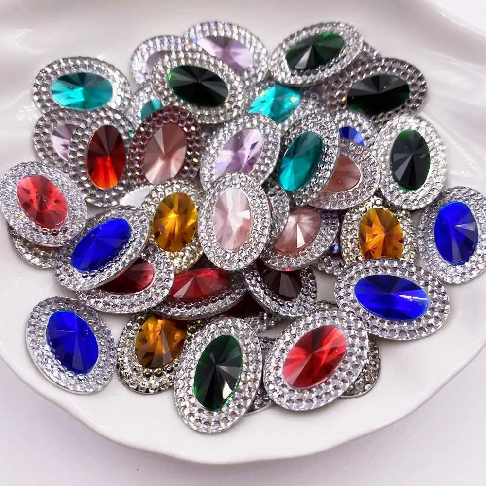 A collection of flatback rhinestone gemstones in various colors and cuts arranged on a white plate.