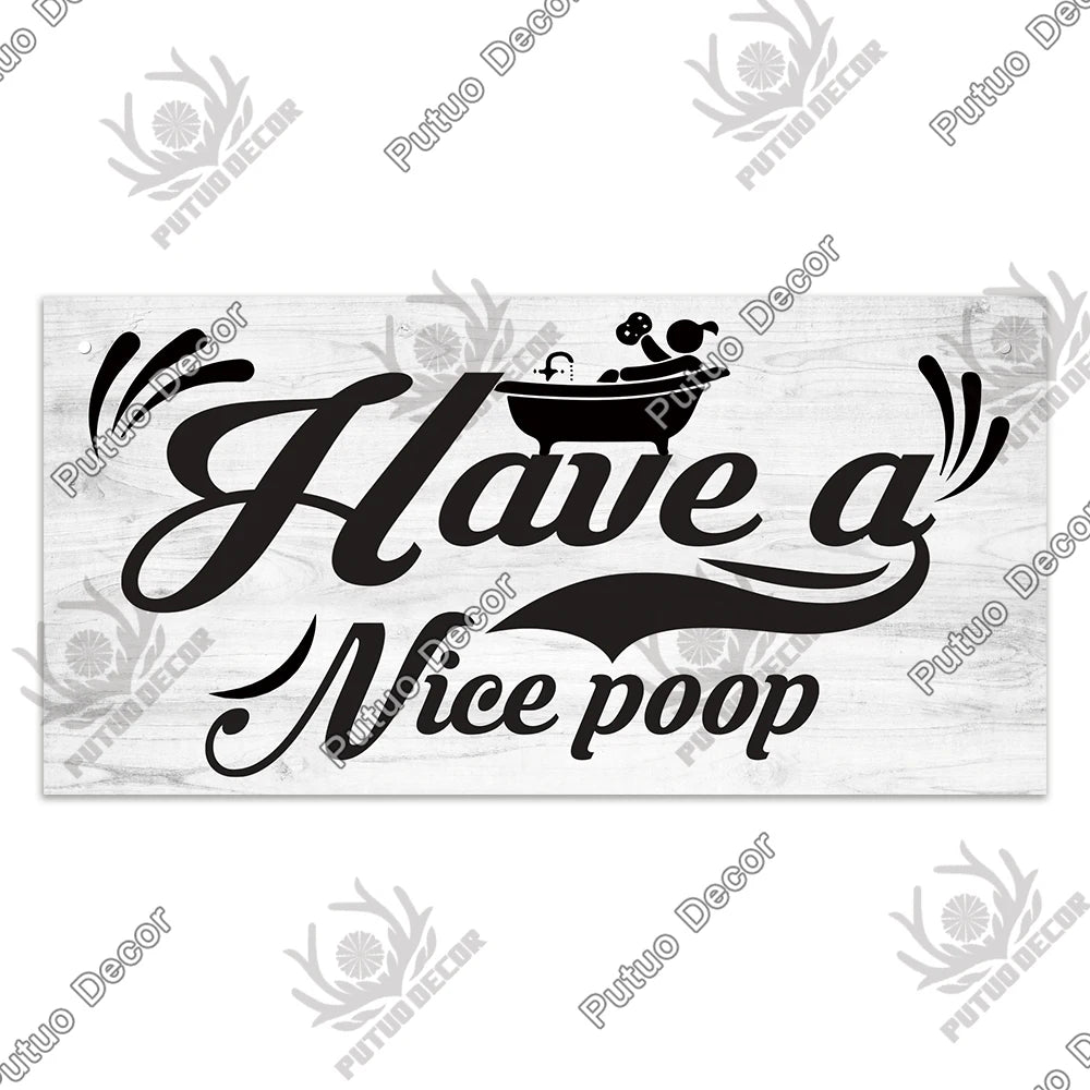 A rustic wooden sign featuring black script that reads Have a Nice poop with a silhouette of a bowl.