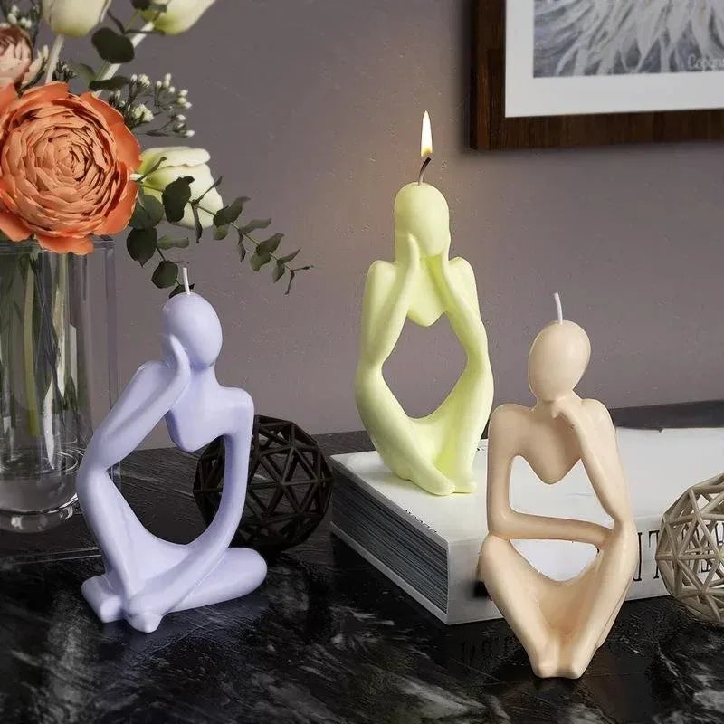 A set of abstract silicone molds in pale yellow and lavender for resin art and crafting displayed on a dark surface.