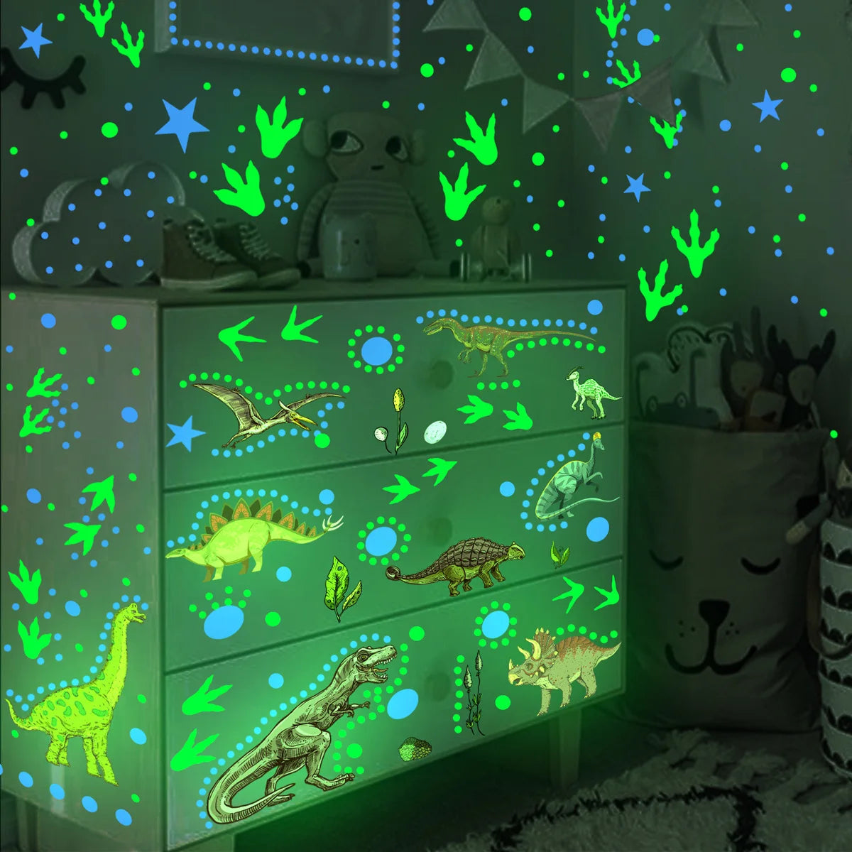 A shelf display of glow-in-the-dark dinosaur wall stickers on a green cabinet with various dinosaur figures and plants.