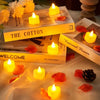 A collection of yellow and orange flameless LED heart-shaped tealight candles resting on a surface with dried flower petals.