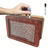A hand places a banknote into a wooden savings box that features a progress tracker grid.