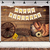 A rustic western backdrop featuring a wooden barn door, hay, and a banner that reads Happy Birthday.
