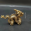 Handcrafted brass Chinese dragon statue with scales and flowing features.