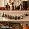 Vintage Halloween wooden hanging garland featuring retro pumpkin, ghost, and cat beads displayed on a shelf.
