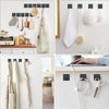 Stainless steel self-adhesive wall hooks hanging various items like towels and tools in a kitchen or bathroom