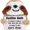 Handmade crochet sloth doll with a positive message card that reads Don't Stop.