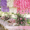 Pink and purple artificial wisteria flower garlands hanging indoors or outdoors